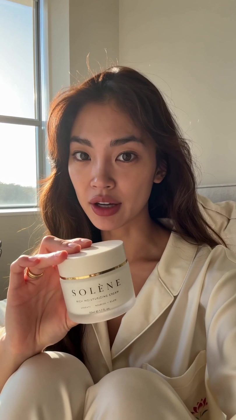 SOLÈNE morning routine — woman with jar by bathroom mirror